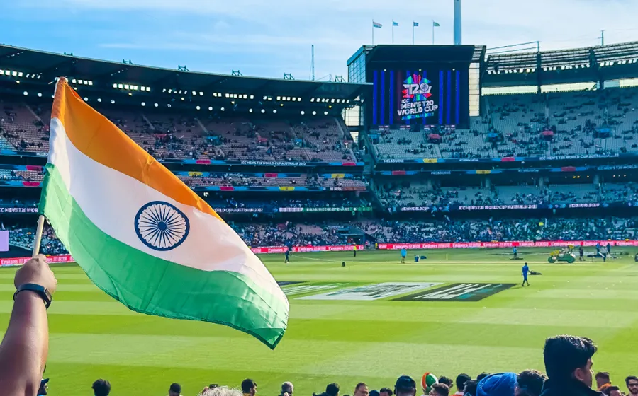 Cricket stadium crowd with a national flag
