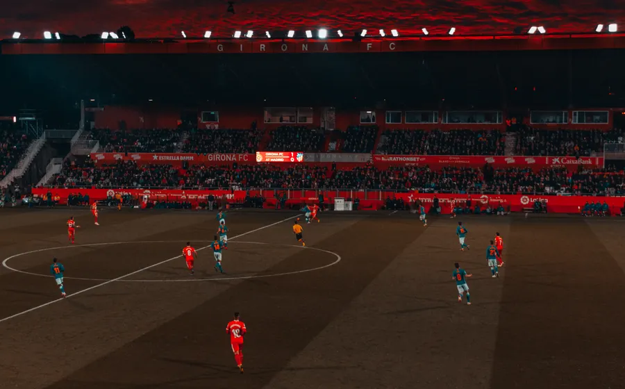 Football match under stadium floodlights