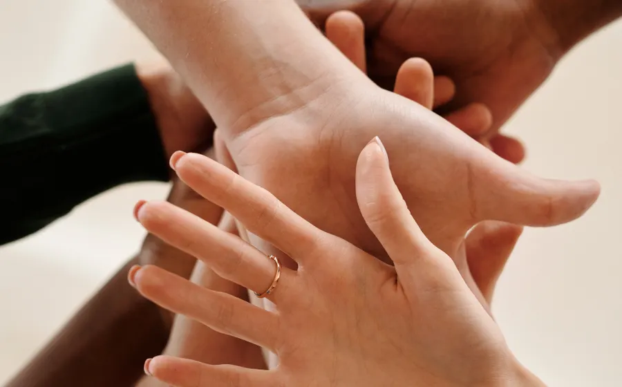 Hands holding a phone with a betting app open